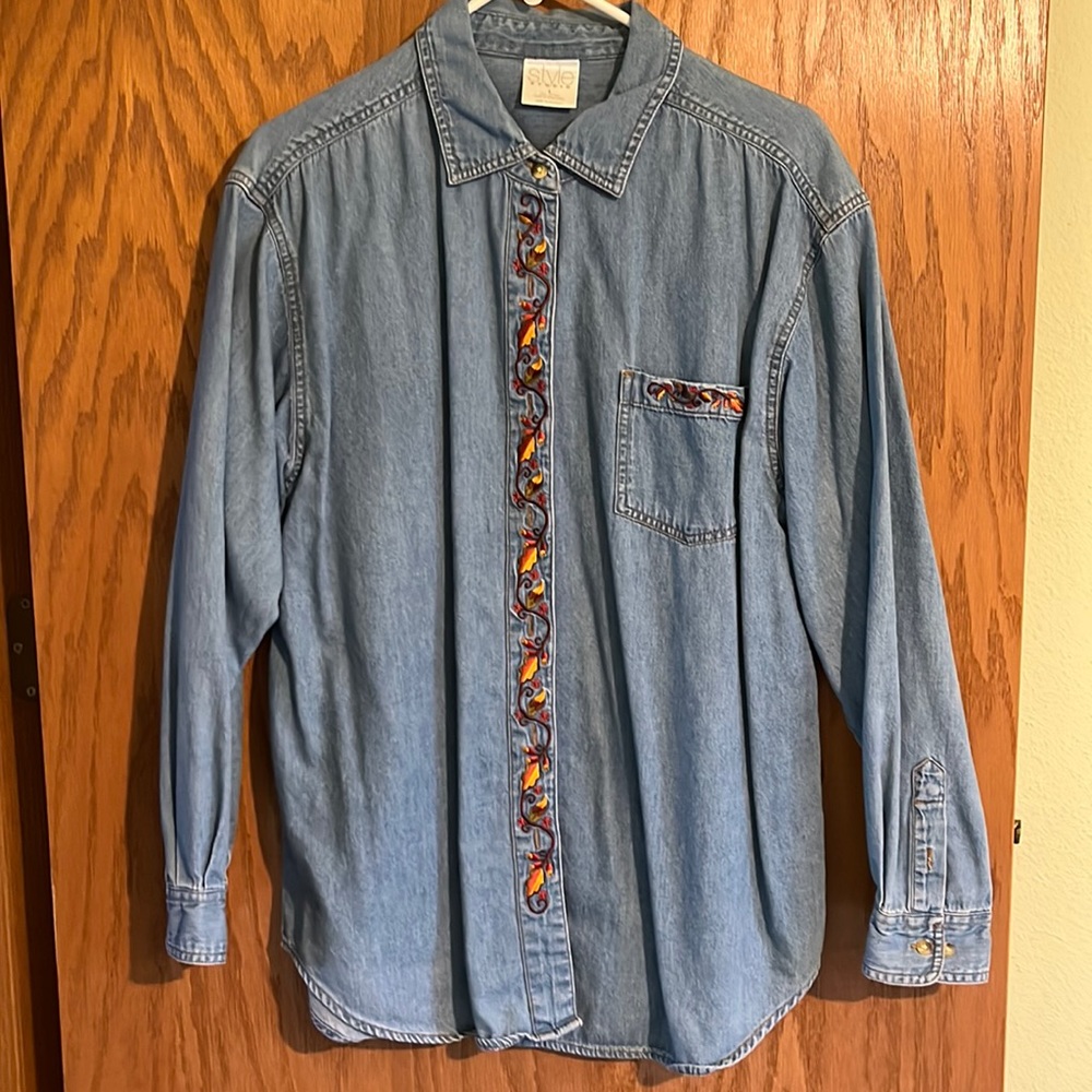 Women’s denim button down shirt with embroidered details.